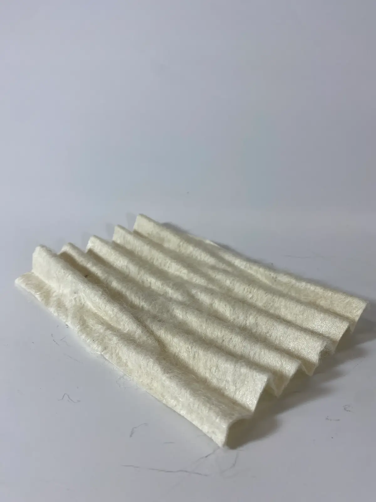 Felt sheet soaked in bio-plastic, pressed in a 3D printed mold.