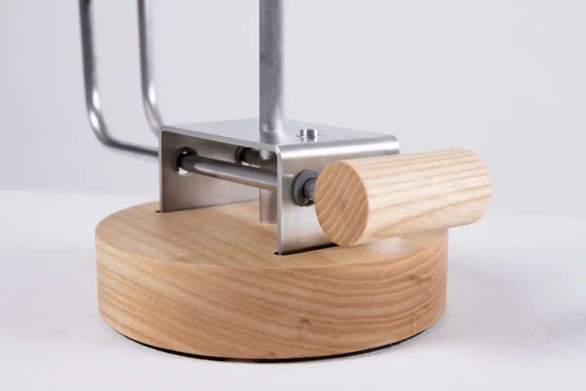 Close-up view of the metal and wood lamp prototype showing the adjustable arm mechanism.
